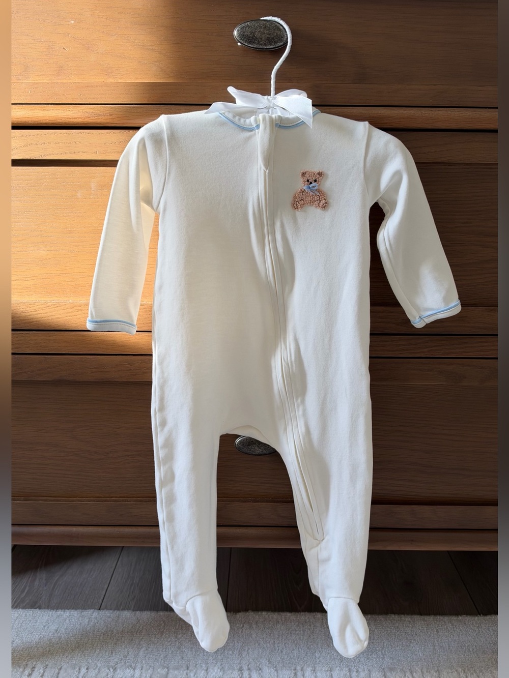 Cream Footed One-Piece with Blue Trim and Teddy Patch